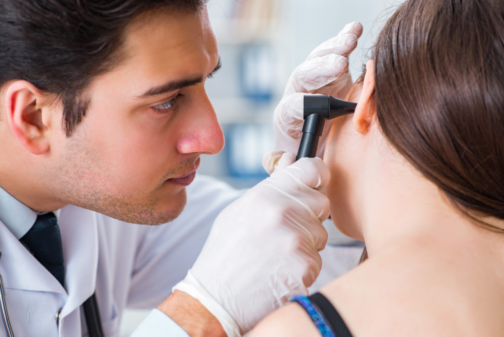 Audiologist Checking For Ear Infection