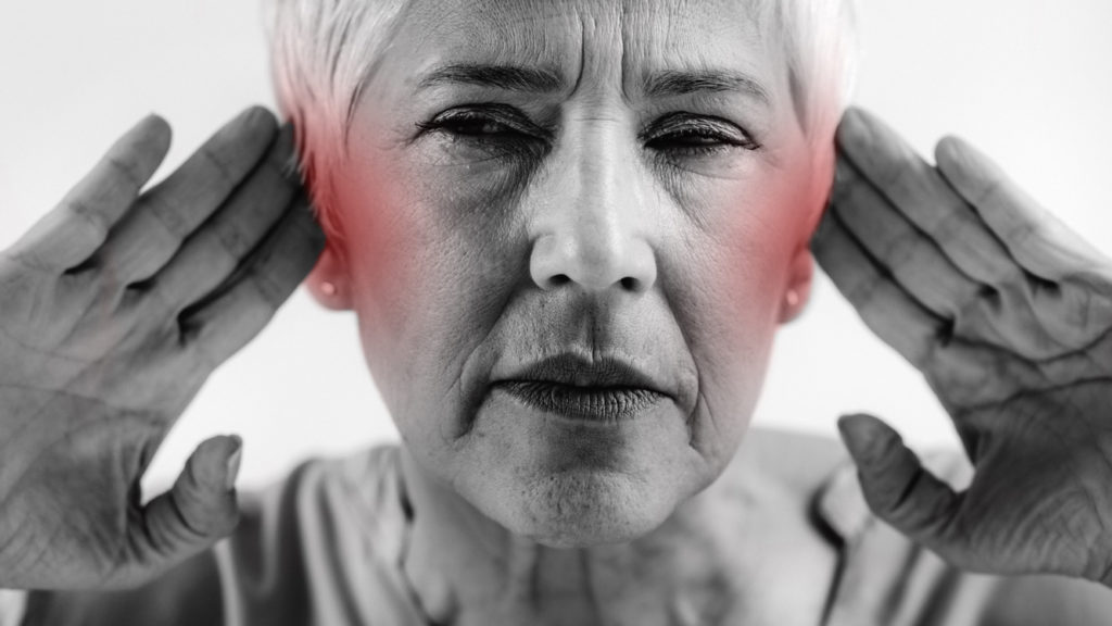 Senior Woman Suffering From Tinnitus